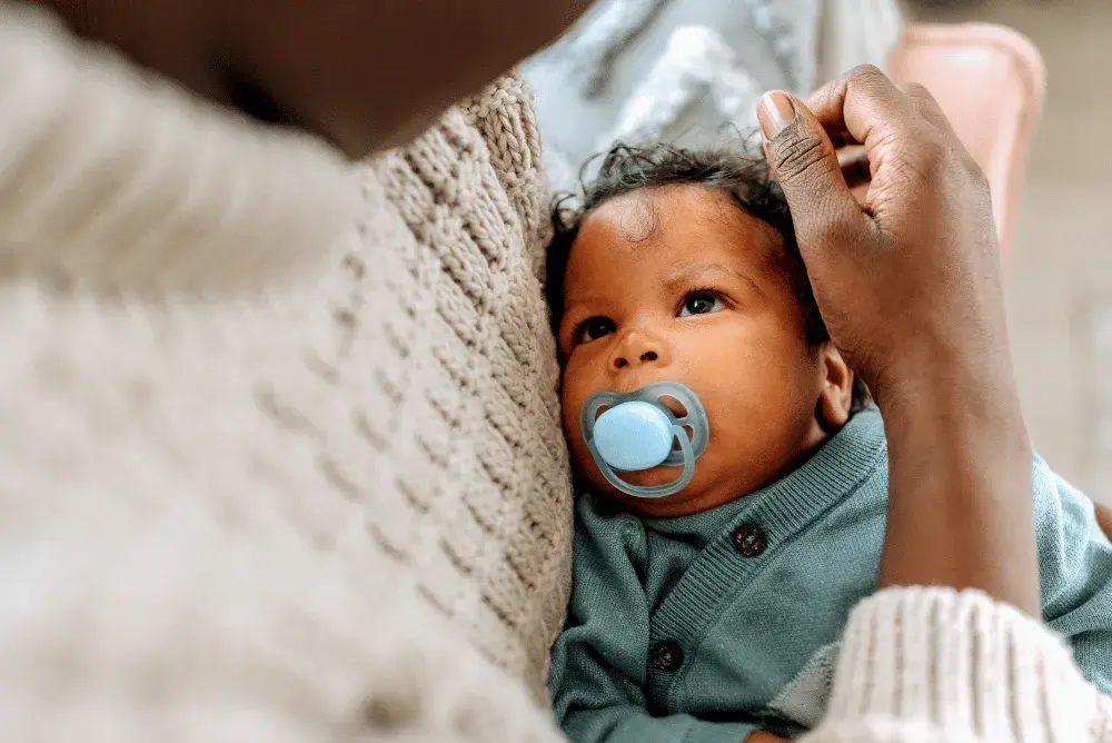 A young baby gazes at his mother's face